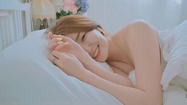 Good morning with young and beautiful Korean woman basking in bed