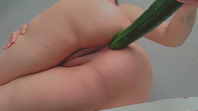 Busty brunette fucks all her tight holes with a cucumber that she further made a salad with