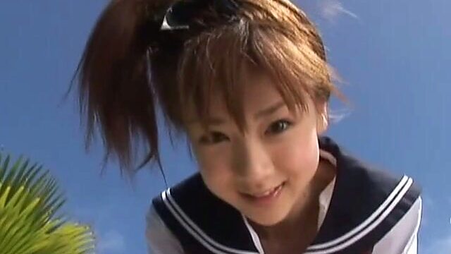 Japanese teen Aki Hoshino plays outside in the sailor outfit