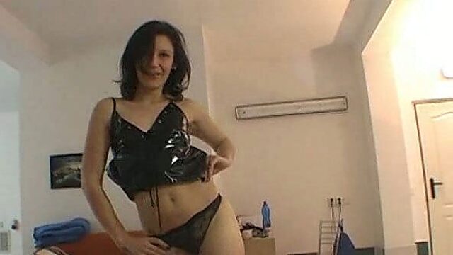 Sexy brunette slut in black vinyl mini dress strips naked